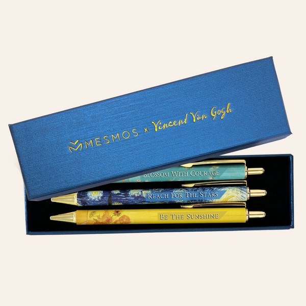 Three Van Gogh inspired ballpoint pens in an open navy gift box marked Mesmos x Vincent Van Gogh.