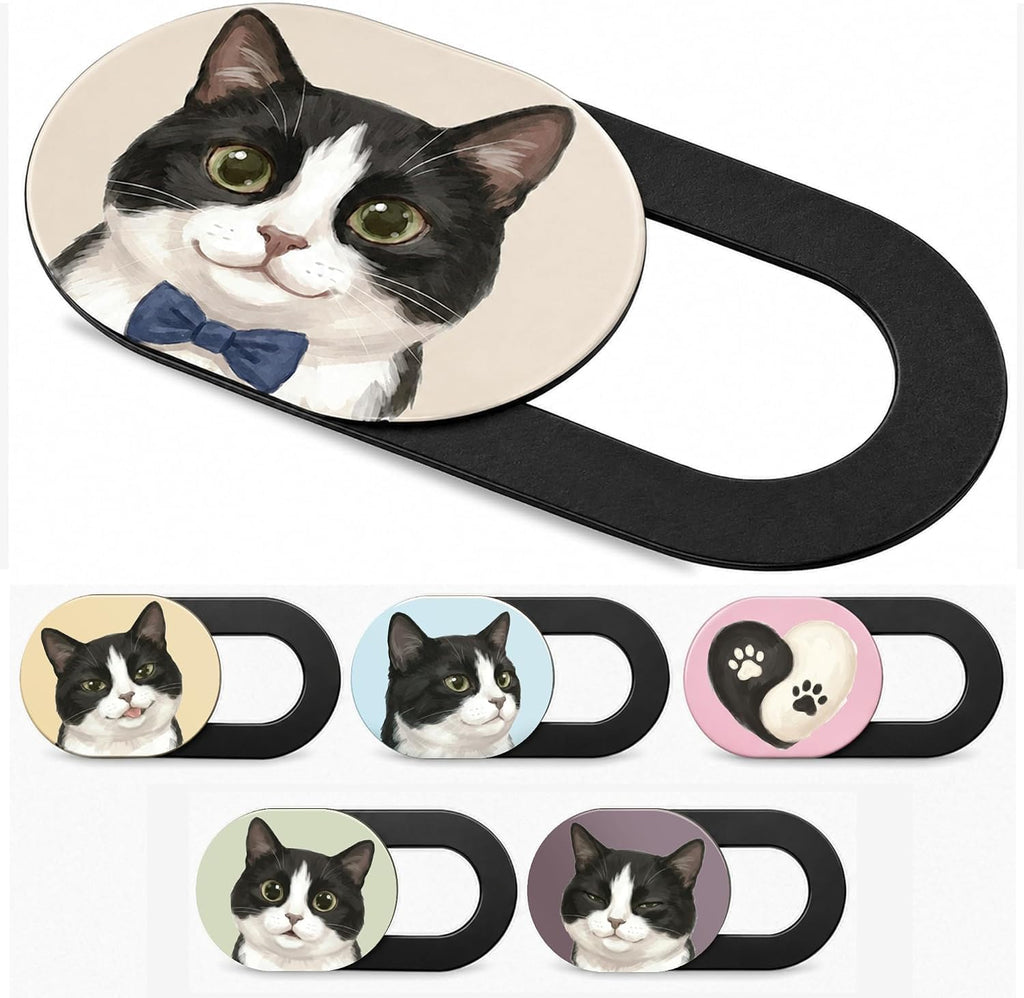 Six black sliding webcam covers, each printed with a different illustrated tuxedo cat face, one wearing a navy bow tie.