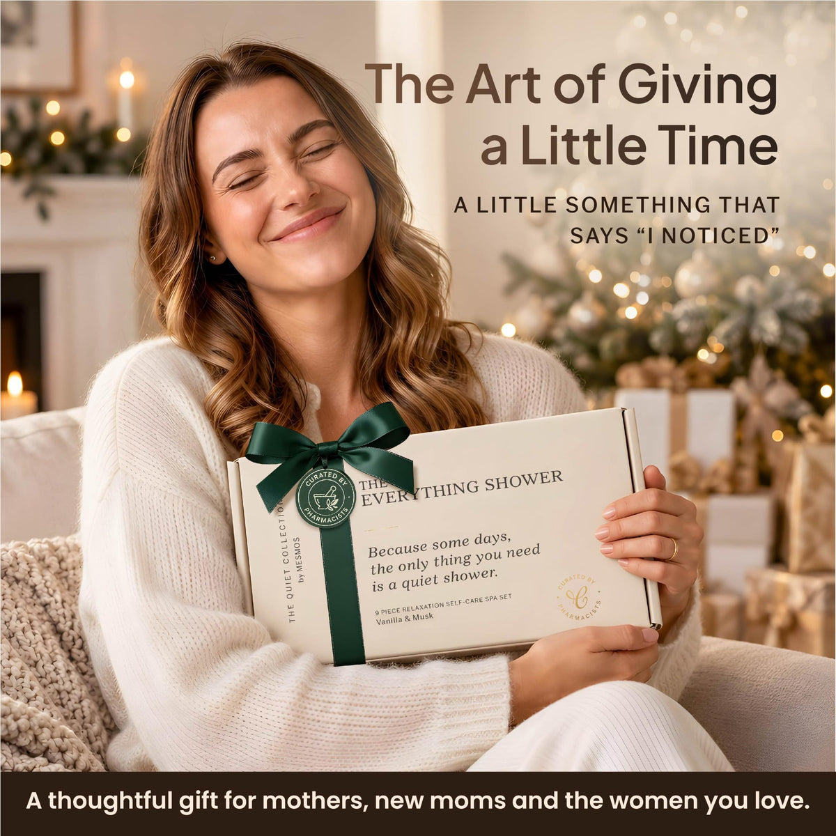 Woman smiling as she hugs The Everything Shower gift box in front of a Christmas tree-