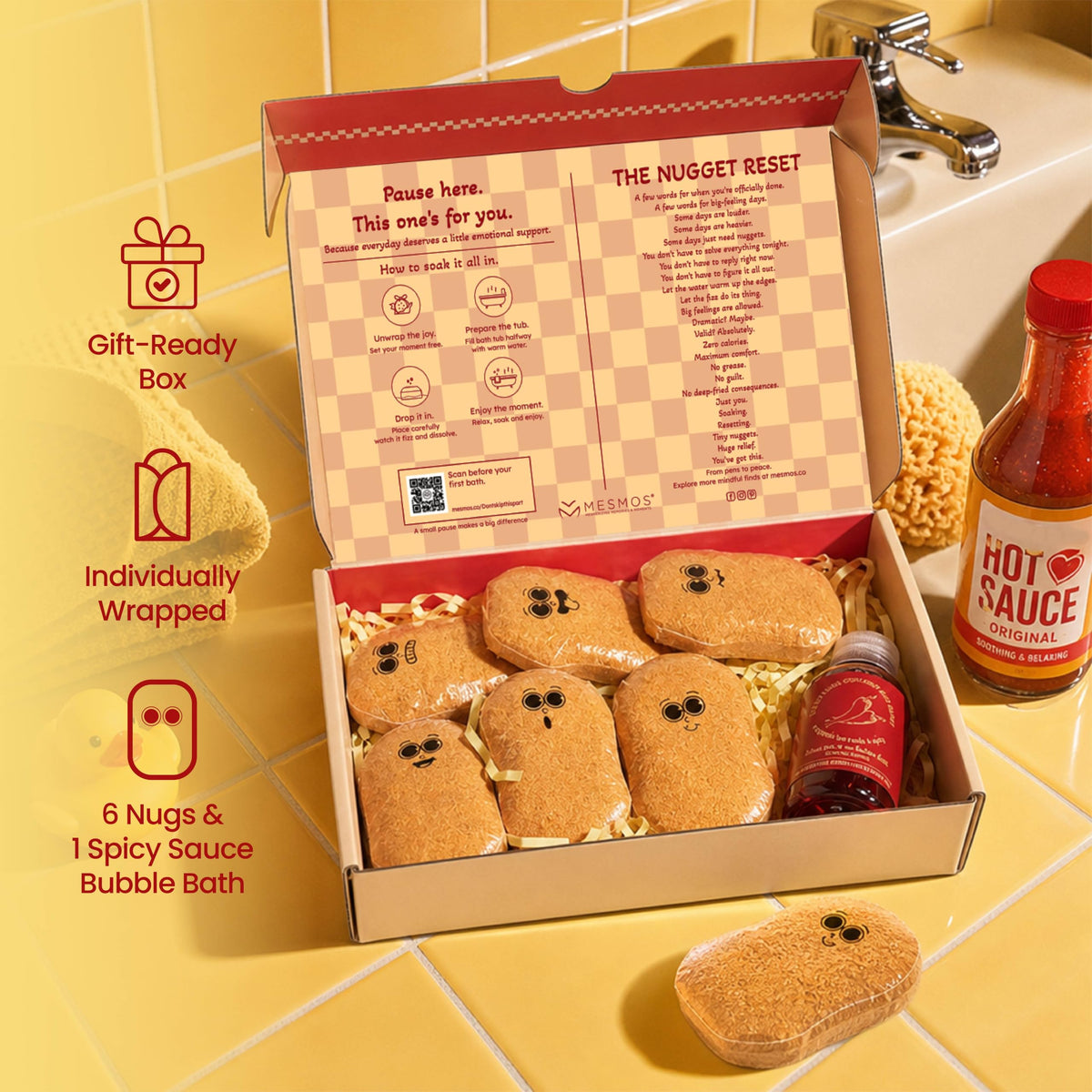 An open takeaway-style box of six nugget-shaped bath fizzers with a bottle of red bubble bath sauce. Gift-ready box, individually wrapped, six nugs and one spicy sauce bubble bath.-