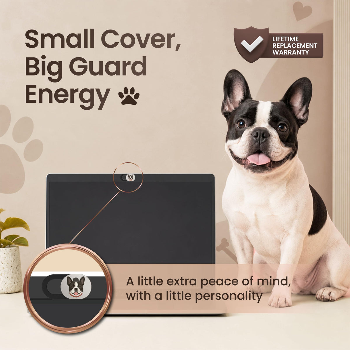 A French bulldog sitting beside a laptop, with a close up of the french bulldog webcam cover fitted over the laptop camera.-