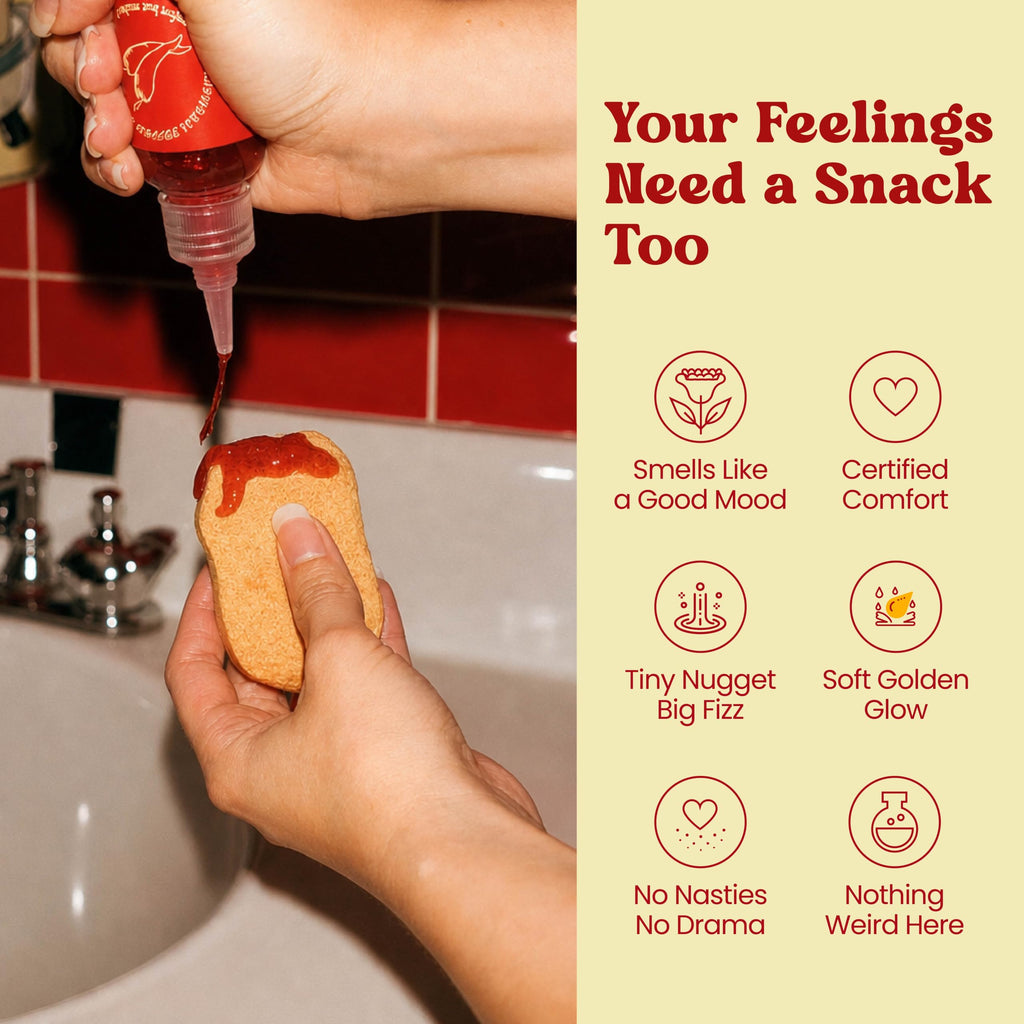 A hand squeezing red bubble bath sauce onto a bath nugget. Your feelings need a snack too: smells like a good mood, certified comfort, tiny nugget big fizz, soft golden glow, no nasties, nothing weird.