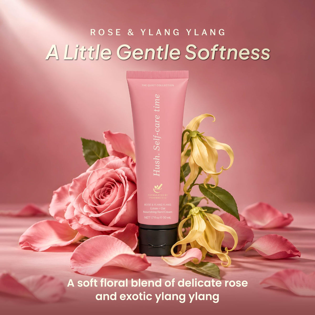 Rose hand cream tube among pink rose petals and yellow ylang ylang flowers-