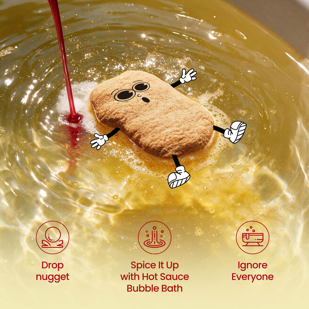 A cartoon-faced bath nugget floating in golden water while red sauce is poured in. Drop the nugget, spice it up with the hot sauce bubble bath, then ignore everyone.