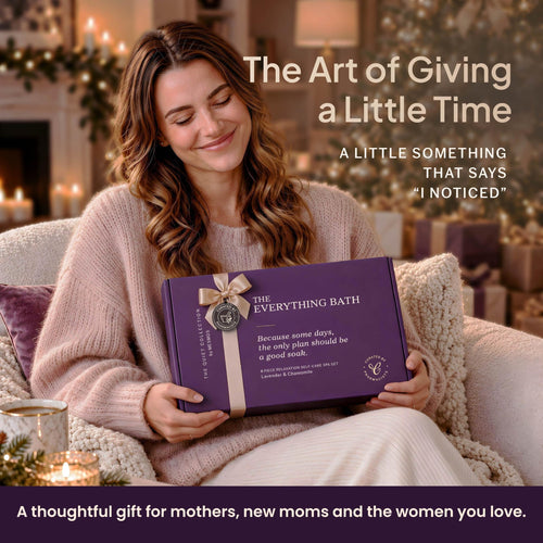 Woman smiling as she holds The Everything Bath gift box by the fireplace, a thoughtful gift for mothers-2