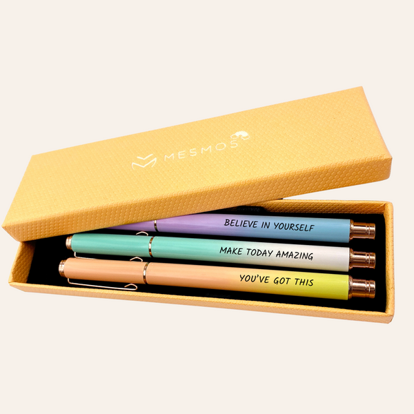 Three pastel pens in an open mustard yellow Mesmos gift box, engraved Believe In Yourself, Make Today Amazing and You've Got This.
