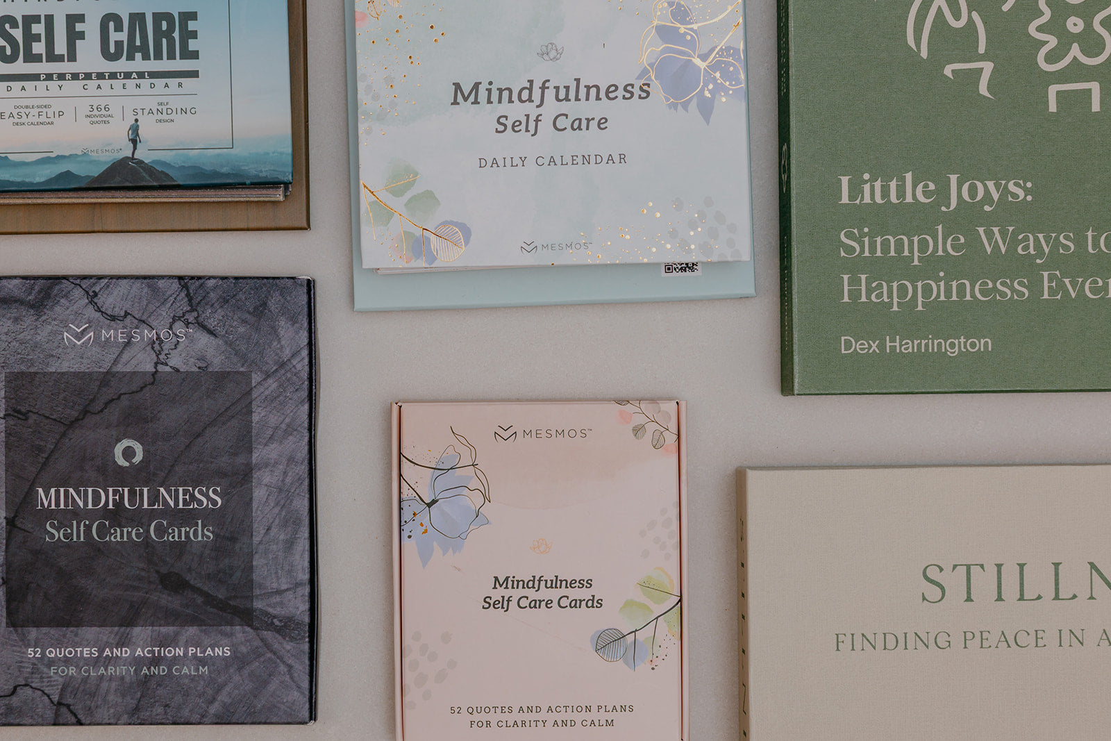 Collection of self-care and mindfulness books and cards on a wall.