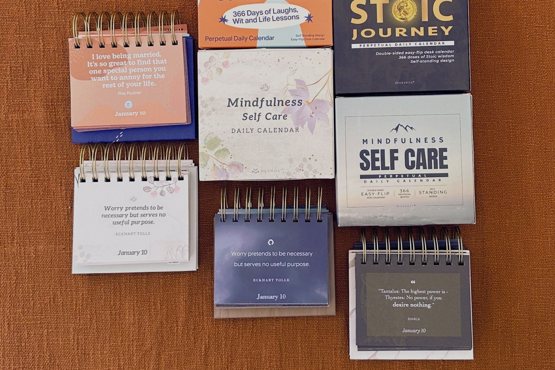Collection of small notebooks with various titles on a wooden surface