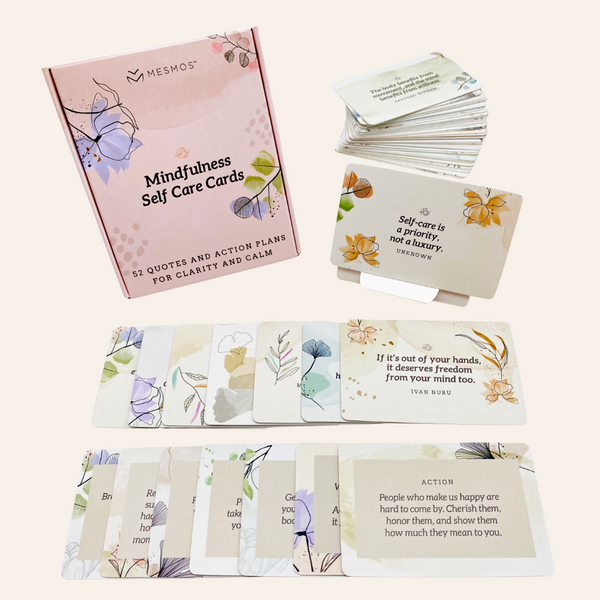The Mindfulness Self Care Cards box with cards fanned out and displayed on a stand - 52 quotes and action plans for clarity and calm, with floral watercolour designs.